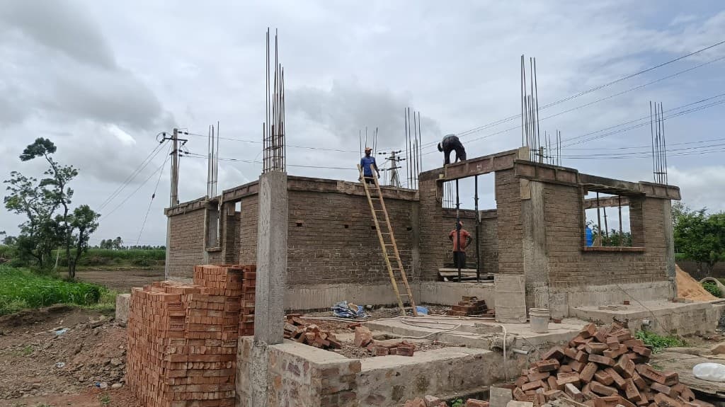 KM Construction residential slab and brickwork in progress with crew on the first floor